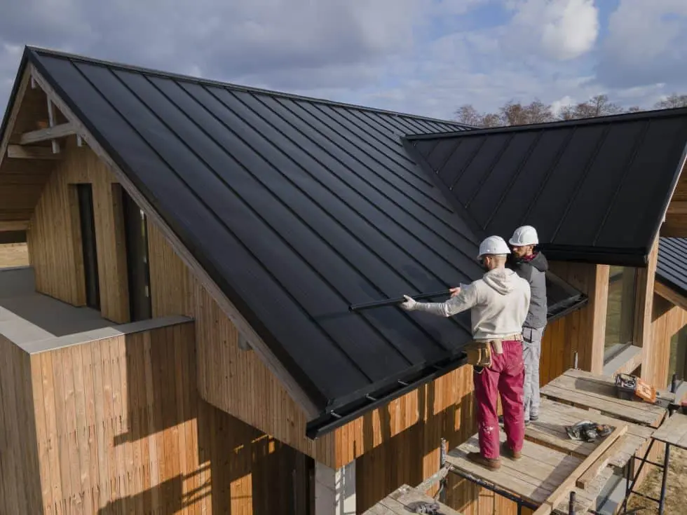 full shot roofers working together with helmets 980x735 1